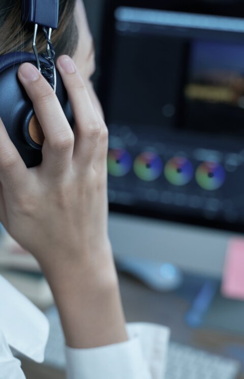 Person wearing headphones in post production
