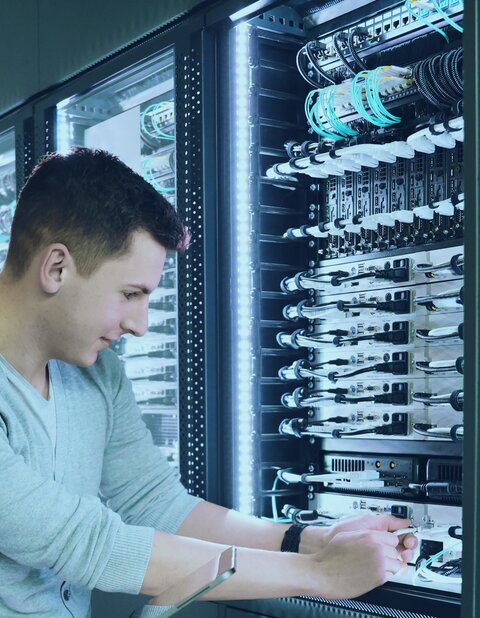 Man working on KVM server rack